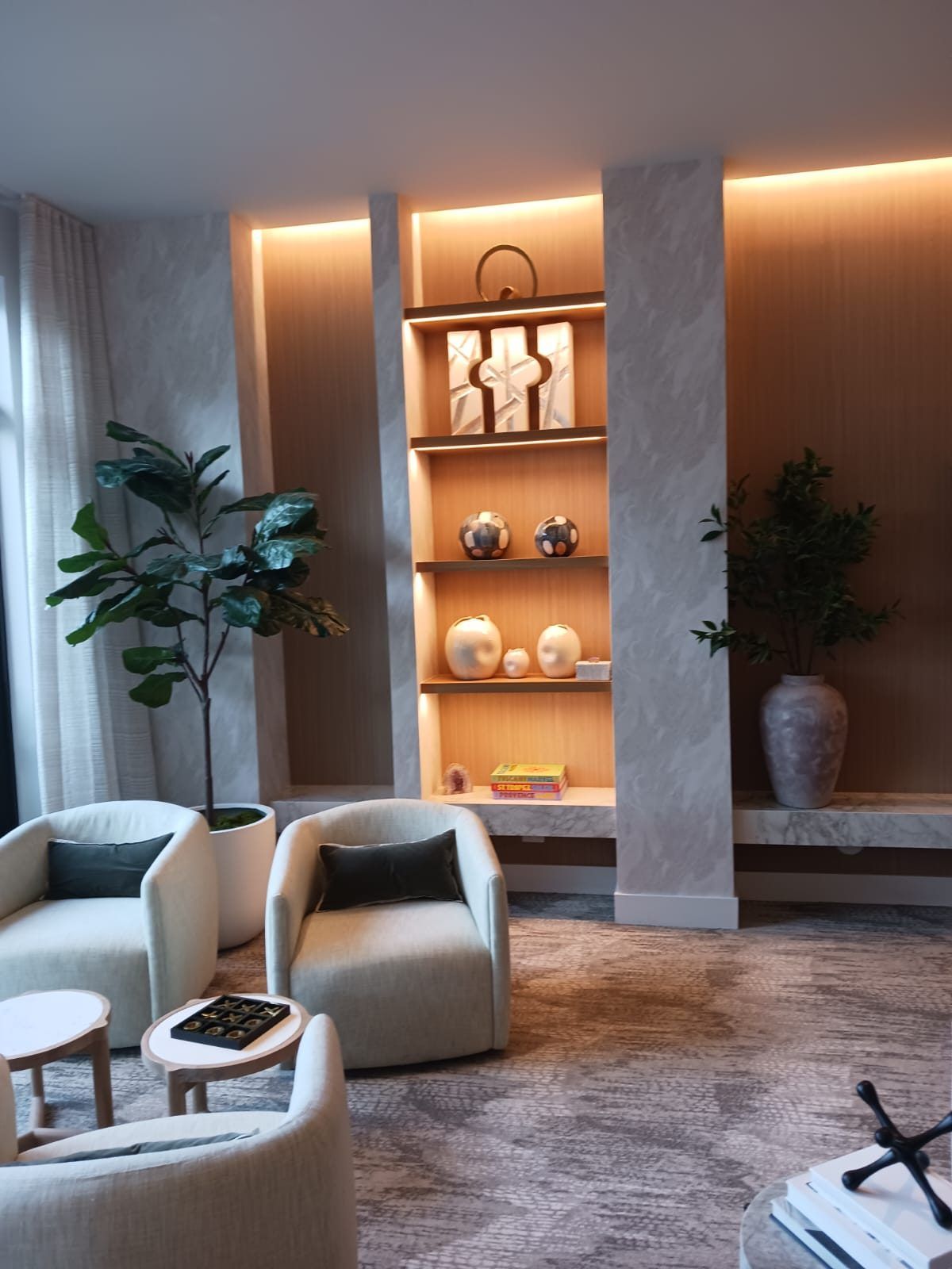 Lounge interior with illuminated display shelving and warm accent lighting