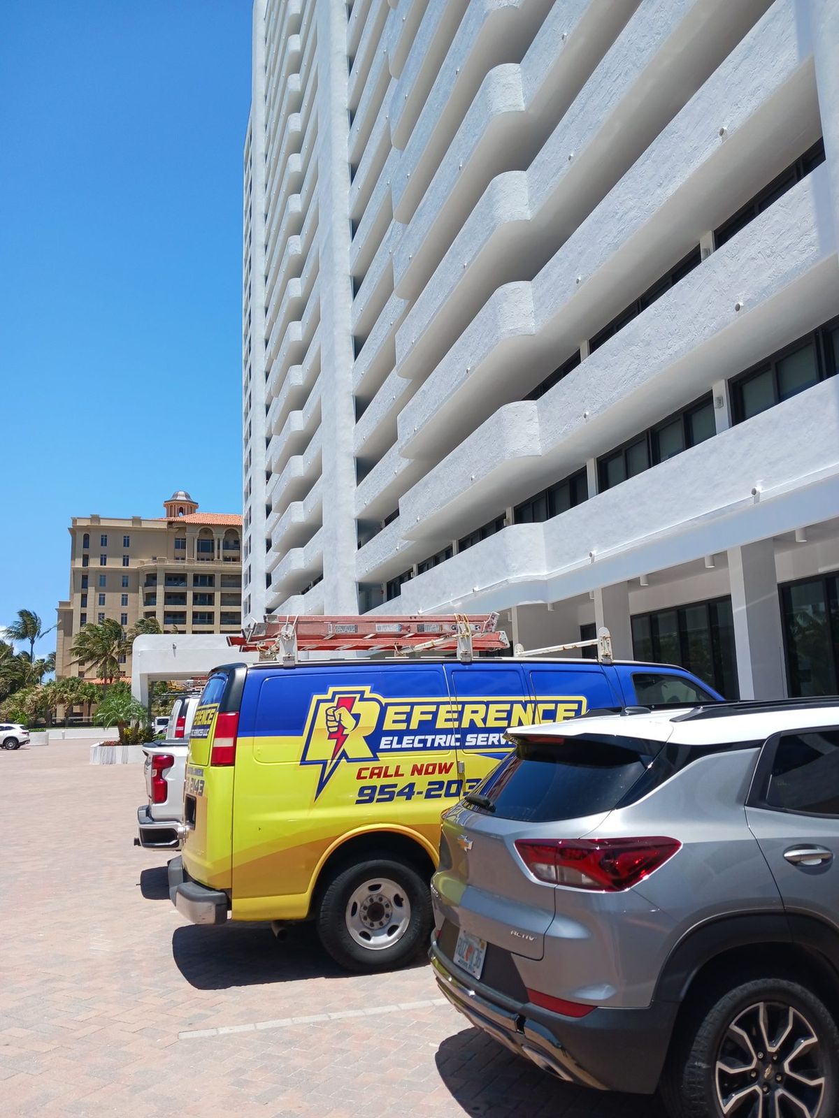 Reference Electric service van parked outside a high rise condominium