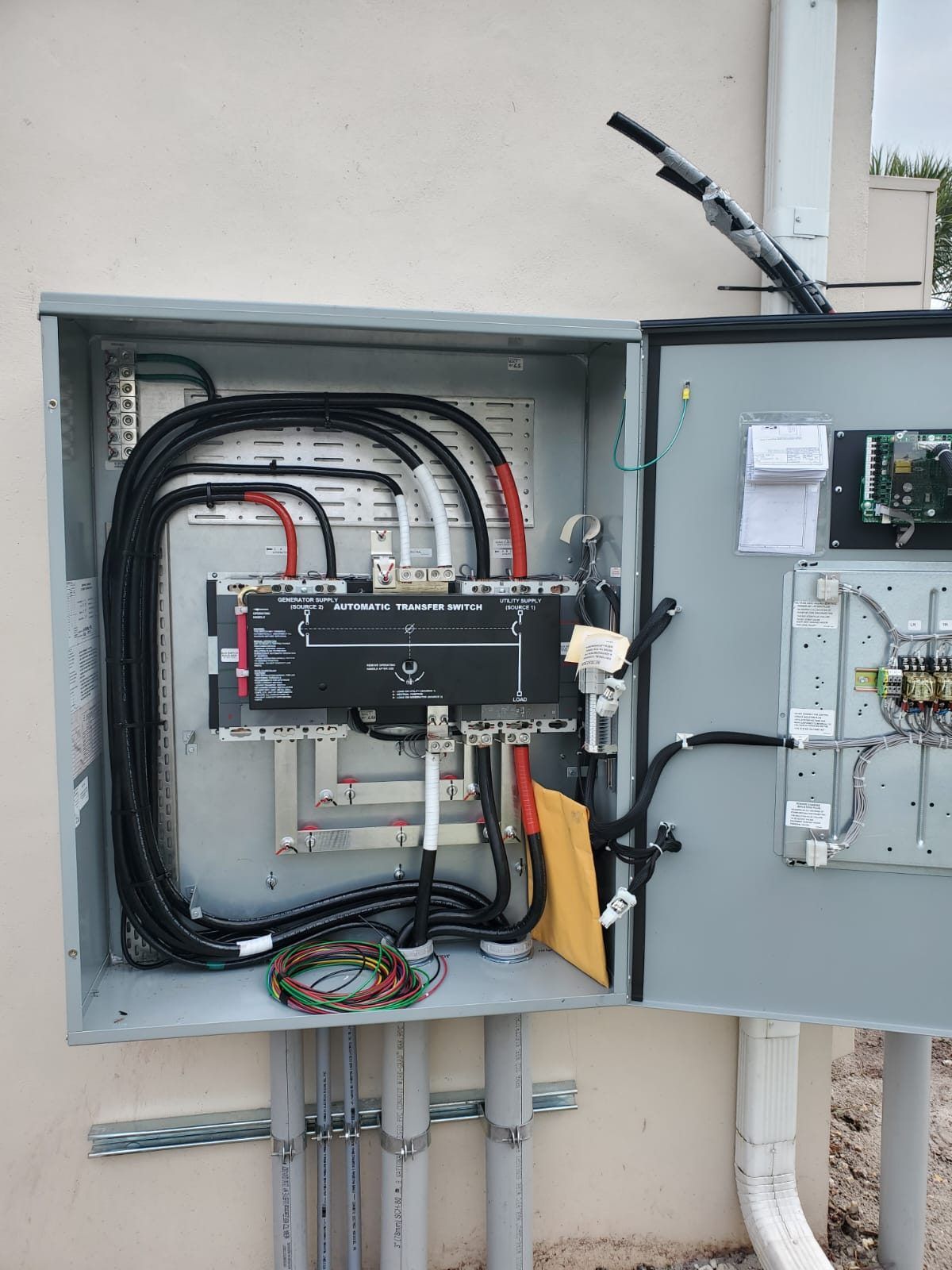 Automatic transfer switch wired inside an outdoor enclosure