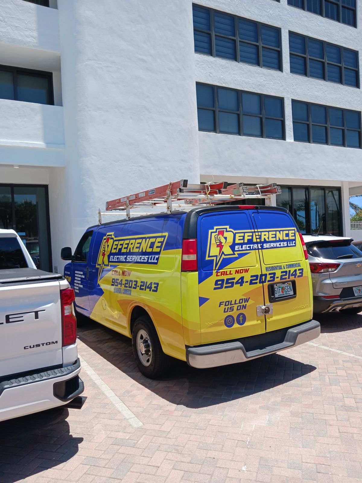 Reference Electric service van in Fort Lauderdale showing the company branding and phone number
